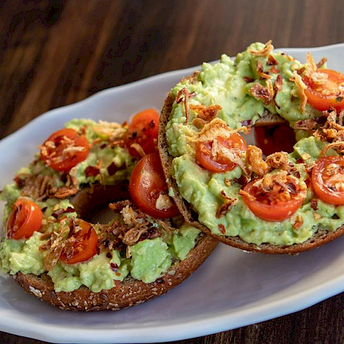 Plate of avocado toast on bagels